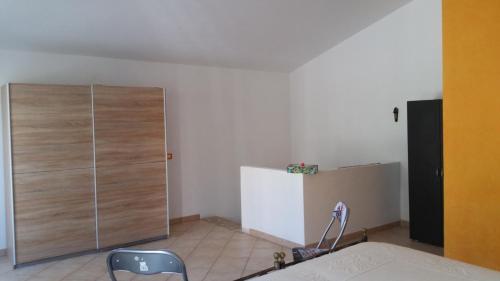 a room with a large wooden cabinet in a room at Casa Allende in Bosa