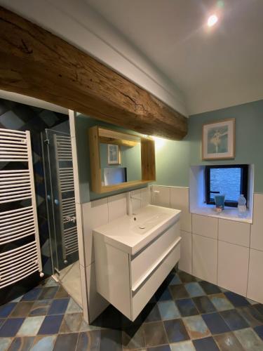 a bathroom with a white sink and a window at Clos La Chavenière in Chissey-lès-Mâcon