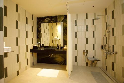 a bathroom with a sink and a mirror at 080 Transit Hotel, T2 in Bangalore