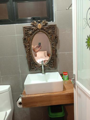 a bathroom with a sink and a mirror at Yana's Place in Donsol