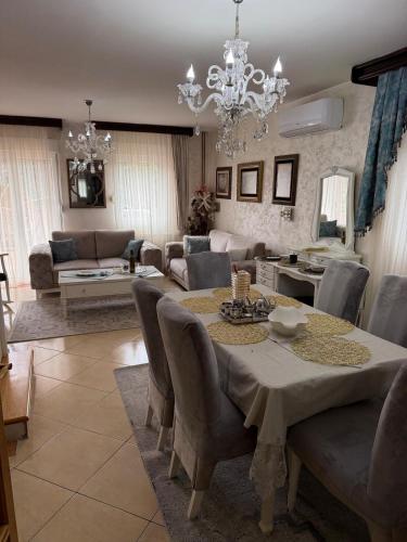 a living room with a table and chairs and a couch at LuxHouseNiksic in Nikšić