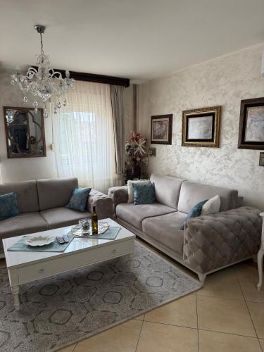 a living room with a couch and a coffee table at LuxHouseNiksic in Nikšić