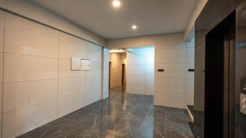 a hallway with white walls and tile floors at Sreebhadra Residency in Chavara