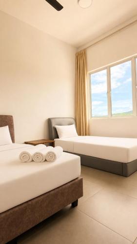 a hotel room with two beds and a window at Casa Le Dream (03) in Kuah