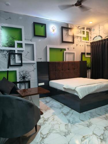 a bedroom with a bed and a chair at Amrit hotel & resort in Nārāyanpur