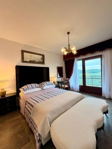 a bedroom with two beds and a large window at Enam Room in Kojsko