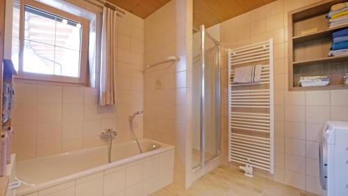 a bathroom with a shower and a tub and a shower at Sonnseit in Sankt Johann in Tirol