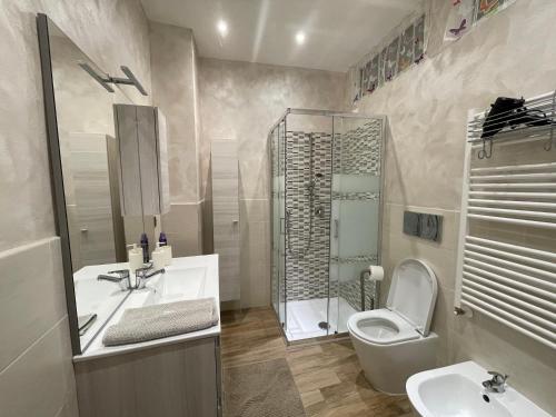 a bathroom with a toilet and a sink and a shower at Priamar house in Savona