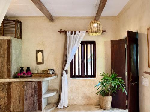 a bathroom with a sink and a window in a room at Palm Grove Beach Resort in Mandrem