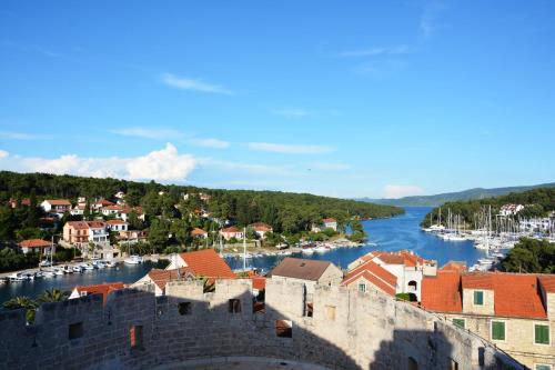 a view of a town with a river and a castle at Apartments Ena in Vrboska