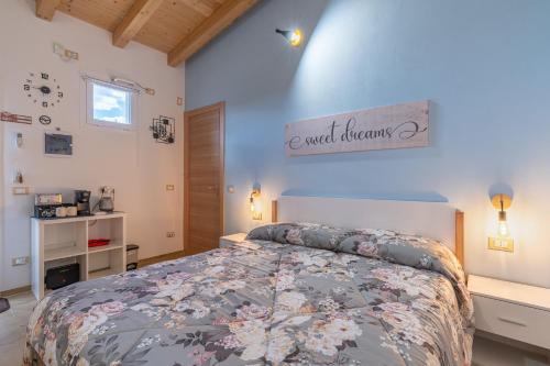 a bedroom with a bed with a floral bedspread at Baglio Netino in Noto