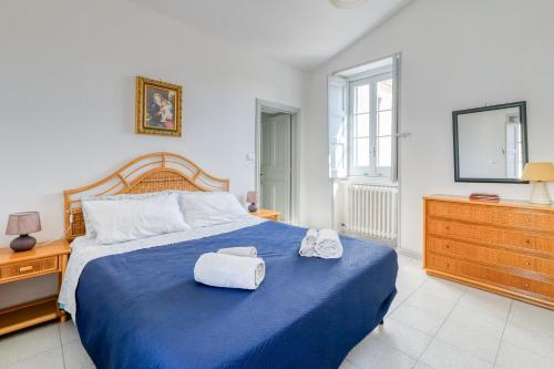 a bedroom with a blue bed with towels on it at Casa in Via Seminario Otranto in Otranto
