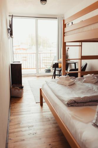 a bedroom with a bed and a table and a window at Fun & Relax Park Thurnau in Thurnau