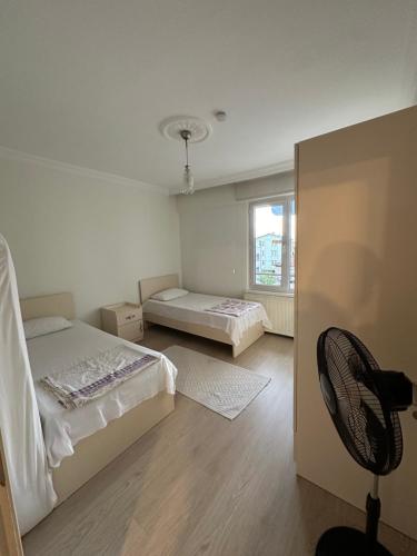 a room with two beds and a chair in it at AiRPORT TO THE HOTEL AND HOME in Pelitli