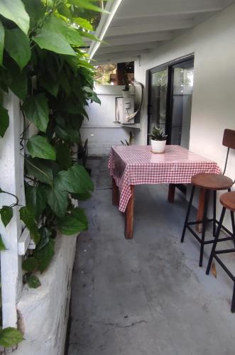a table and chairs in a room with a plant at The Glown Weligama in Weligama