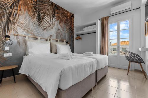 a bedroom with a large bed and a window at Bay's in Spetses