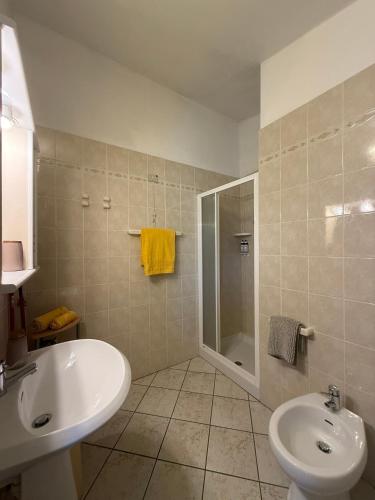 a bathroom with a sink and a toilet and a shower at Agriturismo Gli Ulivi in Garlenda