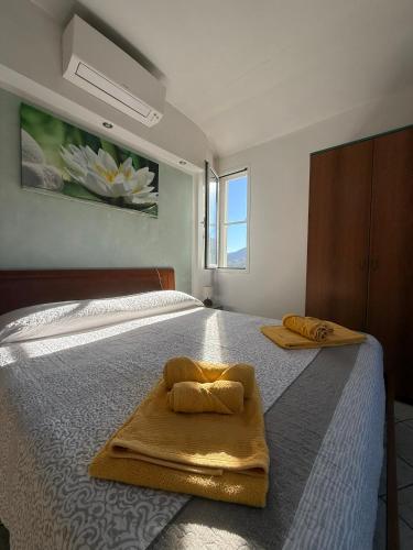 a bedroom with a bed with two towels on it at Agriturismo Gli Ulivi in Garlenda