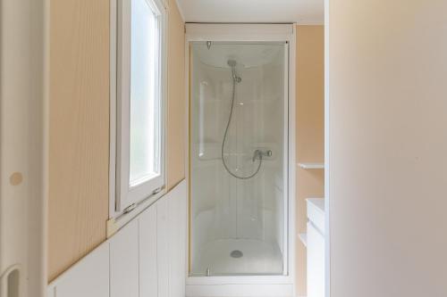 a bathroom with a shower with a glass door at Mobil-home - Le 147 aux Iscles in La Roque-dʼAnthéron