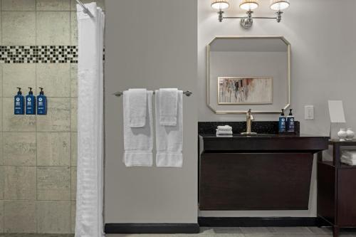 a bathroom with a shower and a sink and a mirror at Club Wyndham Canterbury in San Francisco
