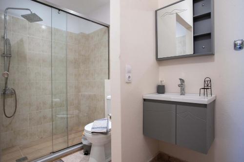 a bathroom with a shower and a sink and a toilet at Thomas Nice View Retreat in Argyroupolis
