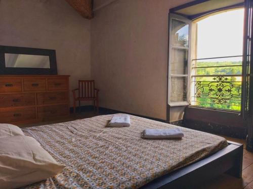 a bedroom with a bed with two towels on it at Chateau de Barral - Piscine privée in Hauterives