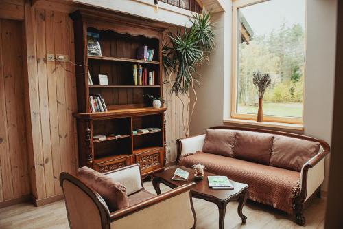 a living room with a couch and a table at River Mind Villa with SPA in Zalioji