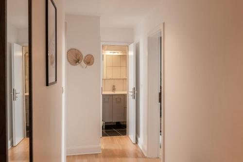 a hallway with a door leading to a kitchen at Downtown by Max, Refuge in city center in Mulhouse