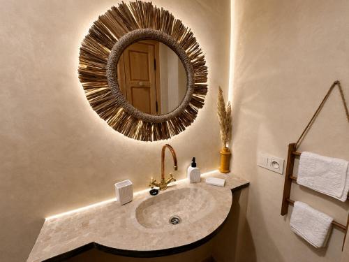 a bathroom with a sink and a mirror at Arya Imsouane in Imsouane