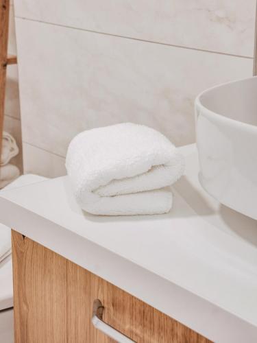 a pile of towels sitting on a counter in a bathroom at Cozy Corner in Bovec