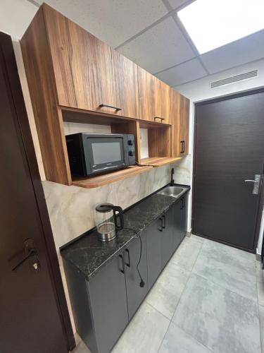 a small kitchen with a microwave and a counter at Хостел Мануфактура in Kharkiv