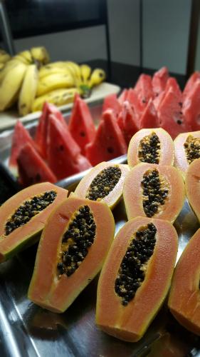 a bunch of papaya cut in half with seeds at Hotel Super Economico in Vitória