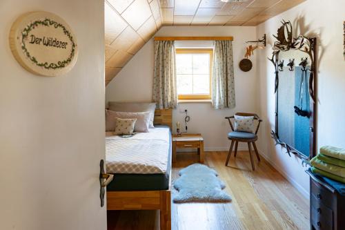 a small bedroom with a bed and a window at Die Hornbacherin in Rottenmann