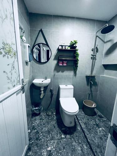 a bathroom with a toilet and a sink at Khaleejay Transient House in Calapan