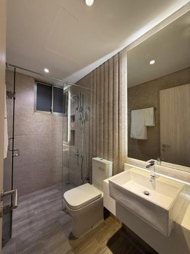 a bathroom with a toilet and a sink and a shower at Premium Midtown serviced apartment in Ho Chi Minh City