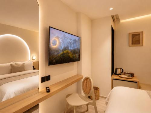 a hotel room with a bed and a mirror at CORRIDOR 2407 in Bangkok