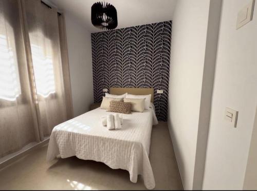 a bedroom with a bed with two towels on it at Elegante Apartamento de 1 Dormitorio en Nerja in Nerja