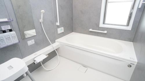 a bathroom with a shower and a toilet and a sink at Sauna villa uchiumi in Uchiumi