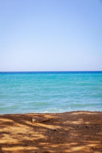 a view of the ocean from the beach at Villa Arancia Private Pool, 2 Jacuzzis & BBQ Area in Pigi