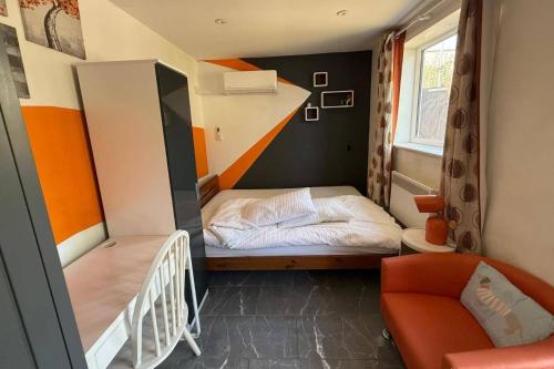 a small room with a bunk bed and a staircase at Studio - Parking - Garden - WiFi - Sleeps 2 in Cambridge