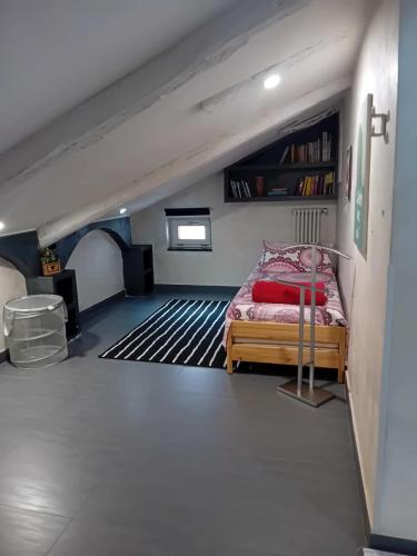 a bedroom with a bed and a book shelf at Monica & Rocco's House in Venaria Reale