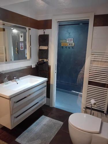 a bathroom with a white sink and a toilet at Monica & Rocco's House in Venaria Reale