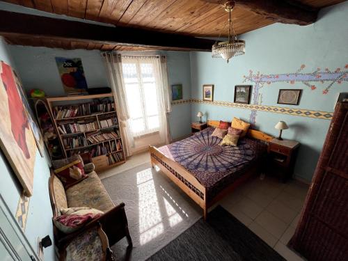 a bedroom with a bed and a table in a room at Midi À La Place in Rians