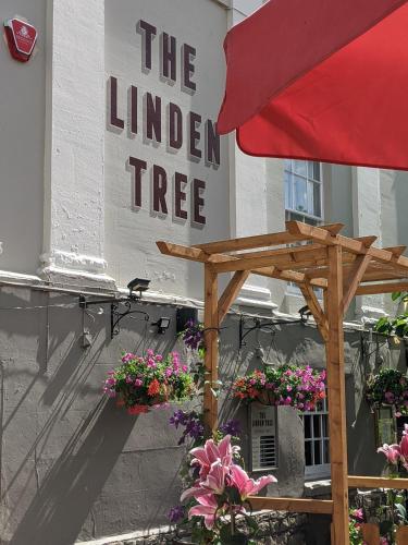 a sign for a timber tree in front of a building at The Linden Tree in Gloucestershire