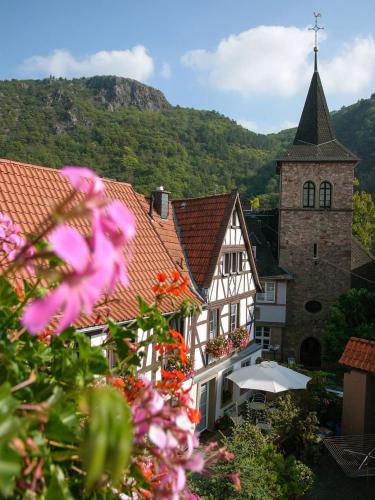 a building with a tower and a church with flowers at Gästehaus Urschel in Bad Kreuznach