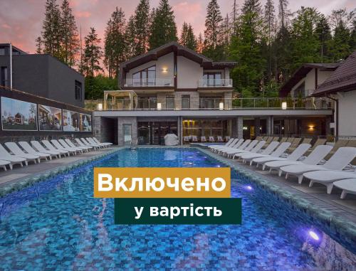 a villa with a swimming pool in front of a house at Goral Hotel & Spa in Bukovel