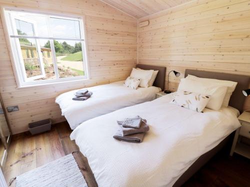 two twin beds in a room with a window at Skylark in Ross on Wye