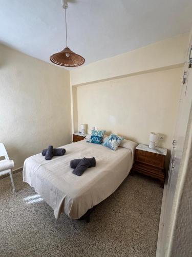 a bedroom with a large bed with blue pillows at Brisa azul in Torrenueva