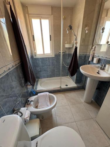 a bathroom with a toilet and a sink and a shower at Brisa azul in Torrenueva