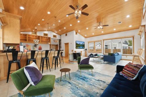 a living room with a bar and a kitchen at Lake Rd E- Geneva in Geneva